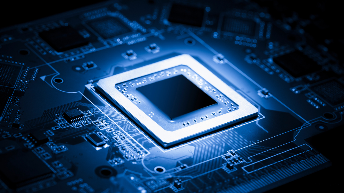 Close-up of a glowing computer chip on a circuit board with visible traces